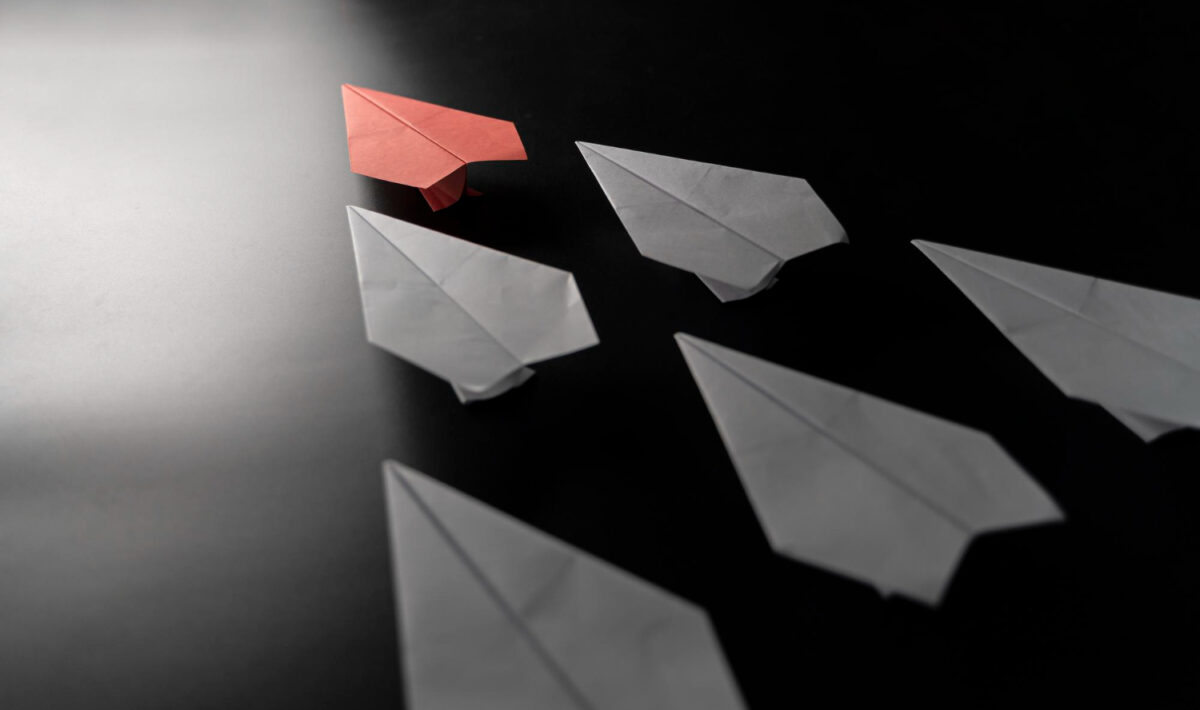 different-thinking-concept-red-paper-plane-leaving-group-red-paper-plane-leading-white-ones